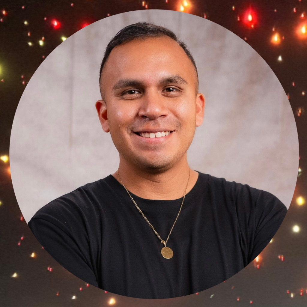 Man smiling with festive lights background